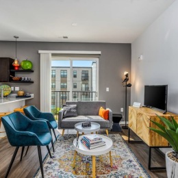 living room with furniture plant and large windows