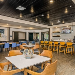 lounge with seating tables and tv 
