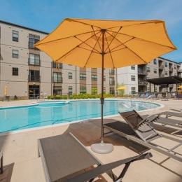 an umbrella and seating by a pool