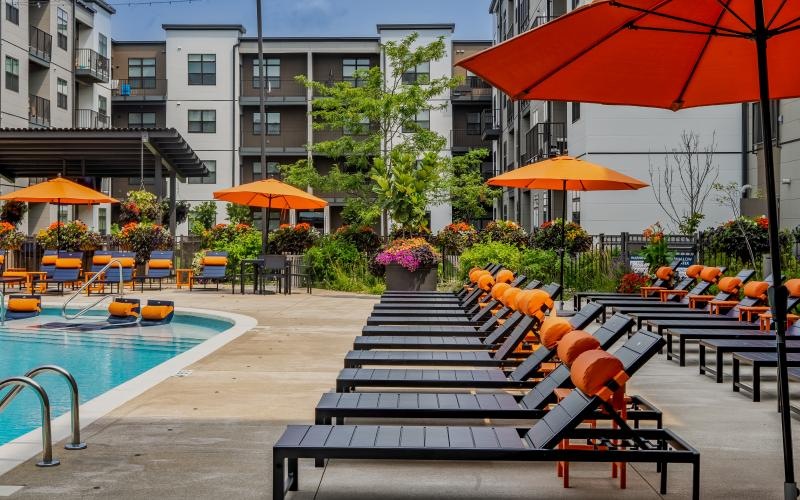 a pool with chairs and umbrellas