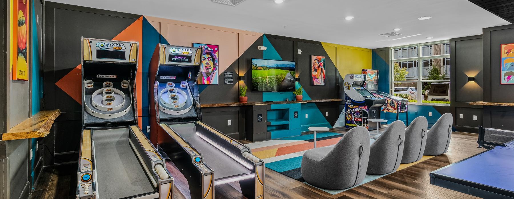 a room with video games and pinball
