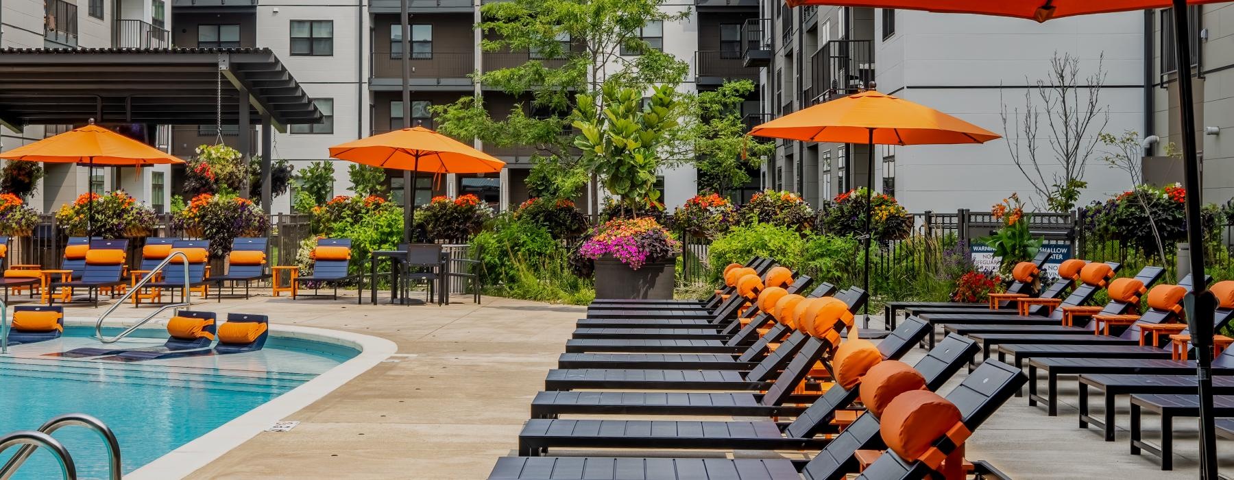 a pool with chairs and umbrellas