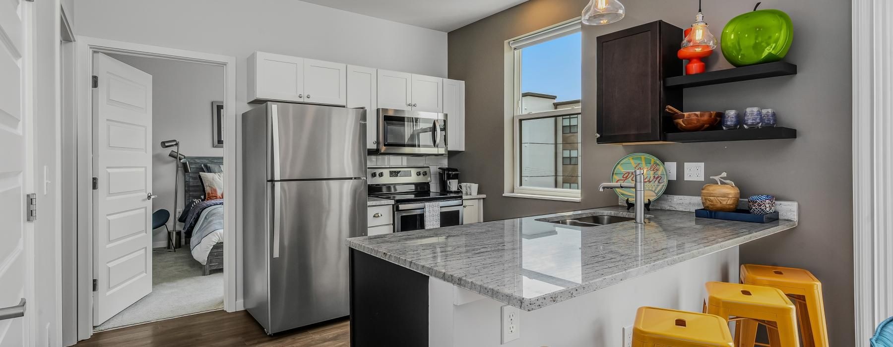 a kitchen with a bar and stools