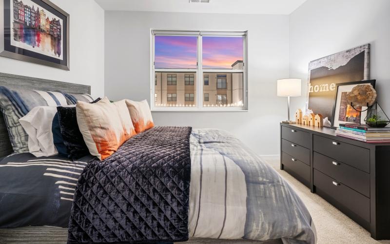 a bedroom with a bed and a dresser